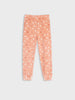Pink children's pants with heart pattern on a light gray background