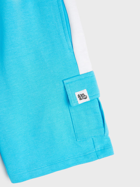 Close-up of a blue shirt with a brand label on a white background