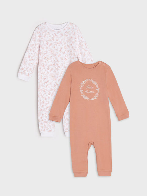 Two baby onesies, one with floral pattern and the other with text design, on a white background.