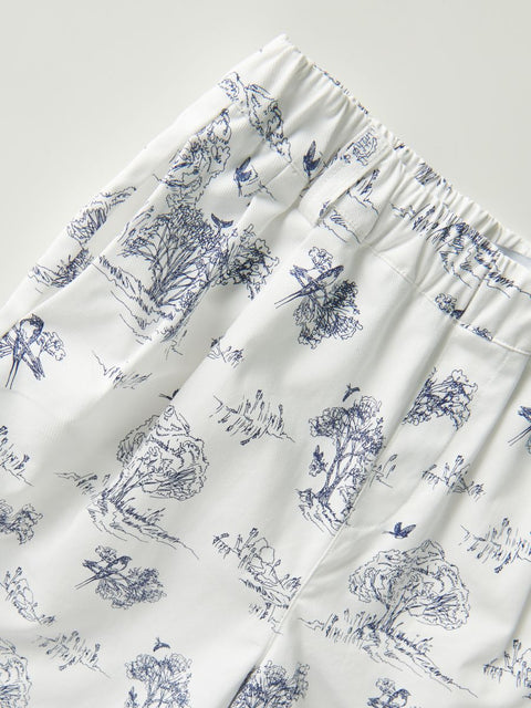 White fabric with blue floral and bird pattern on a white background