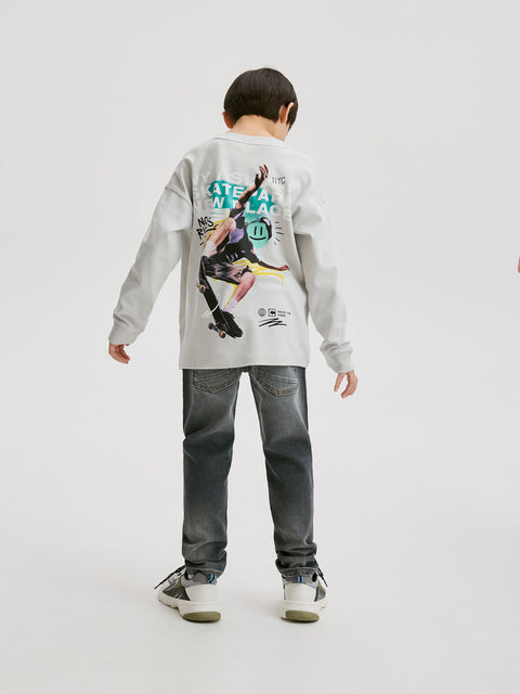 Person wearing a gray sweatshirt with a graphic design on a white background