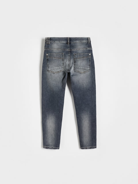 Back view of a pair of blue jeans on a white background