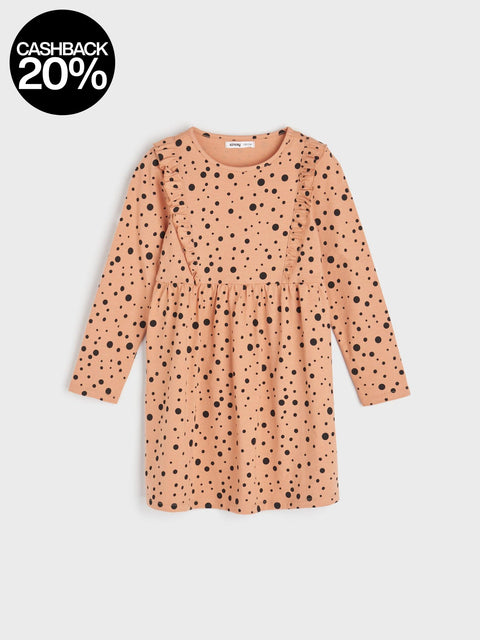 Pink dress with black polka dots on a light gray background
