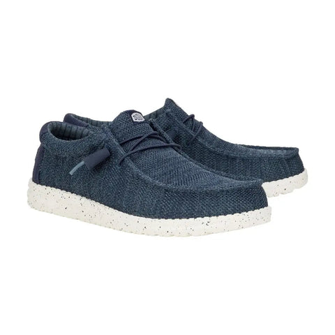 Pair of blue sneakers with white soles on a white background