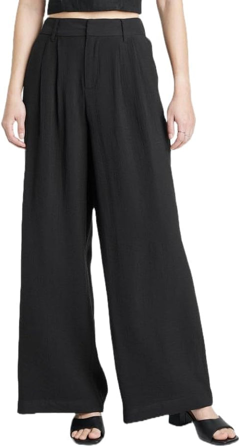 Black wide-leg pants worn by a person on a white background