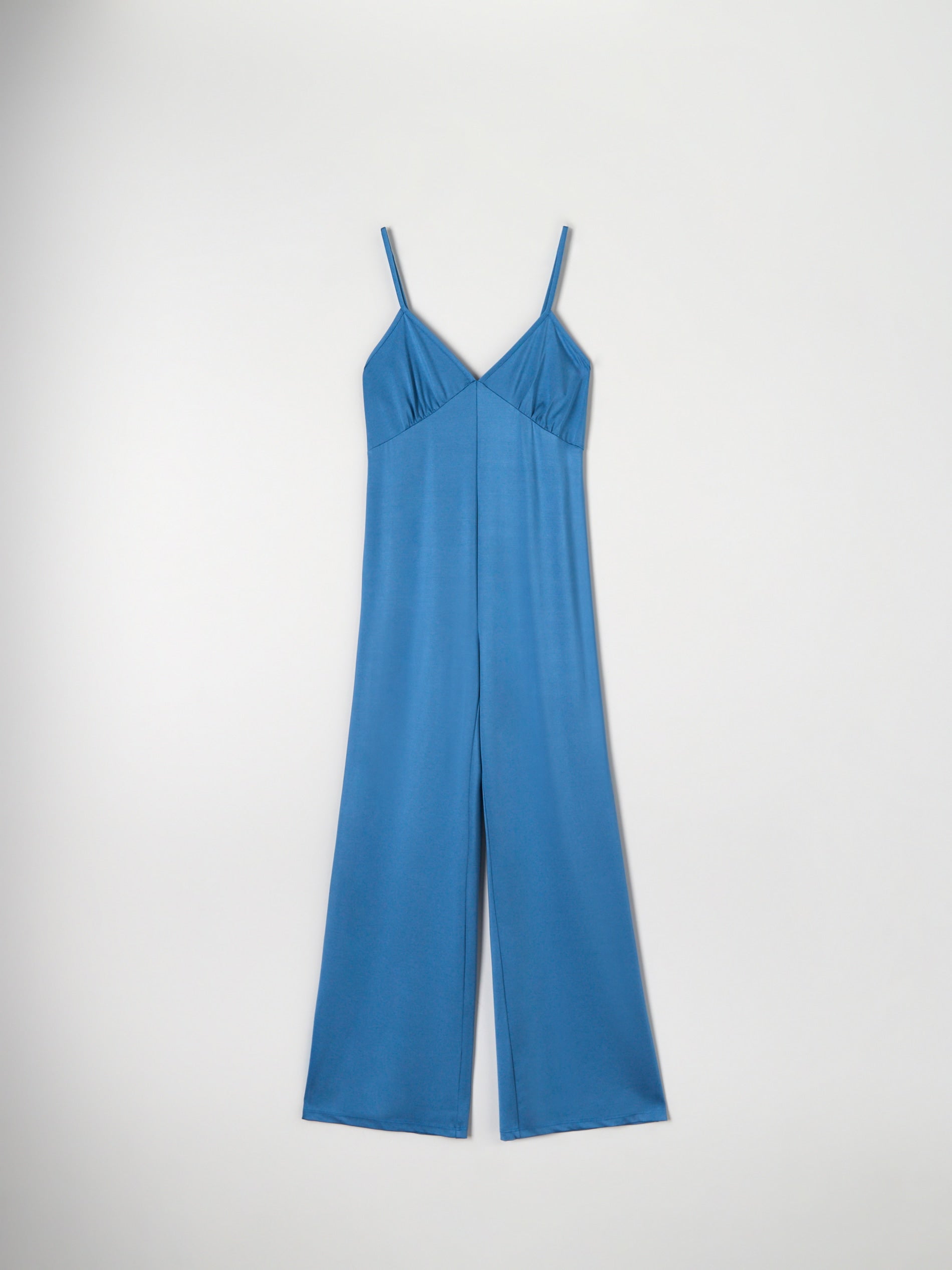 Blue jumpsuit on a light gray background