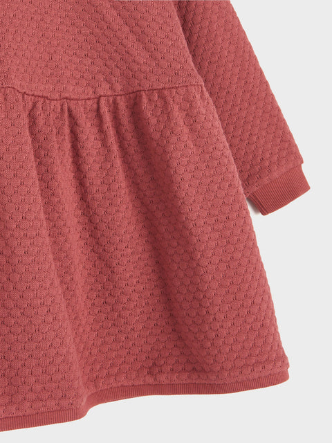Red textured dress on a white background