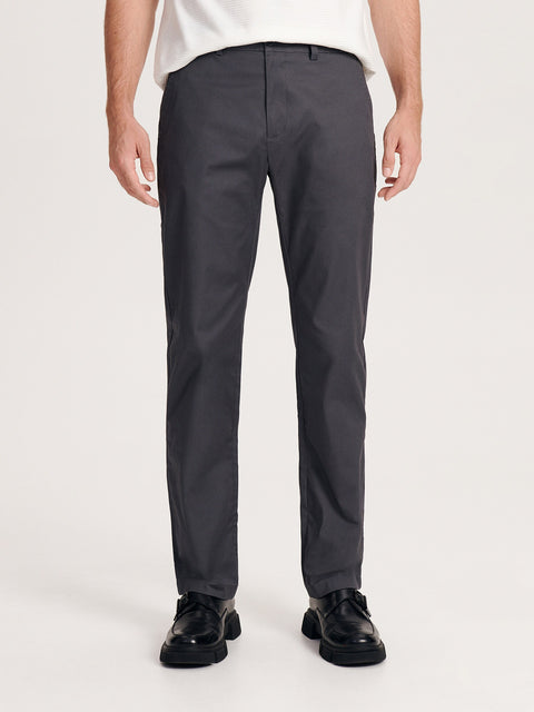 Person wearing dark gray pants on a white background