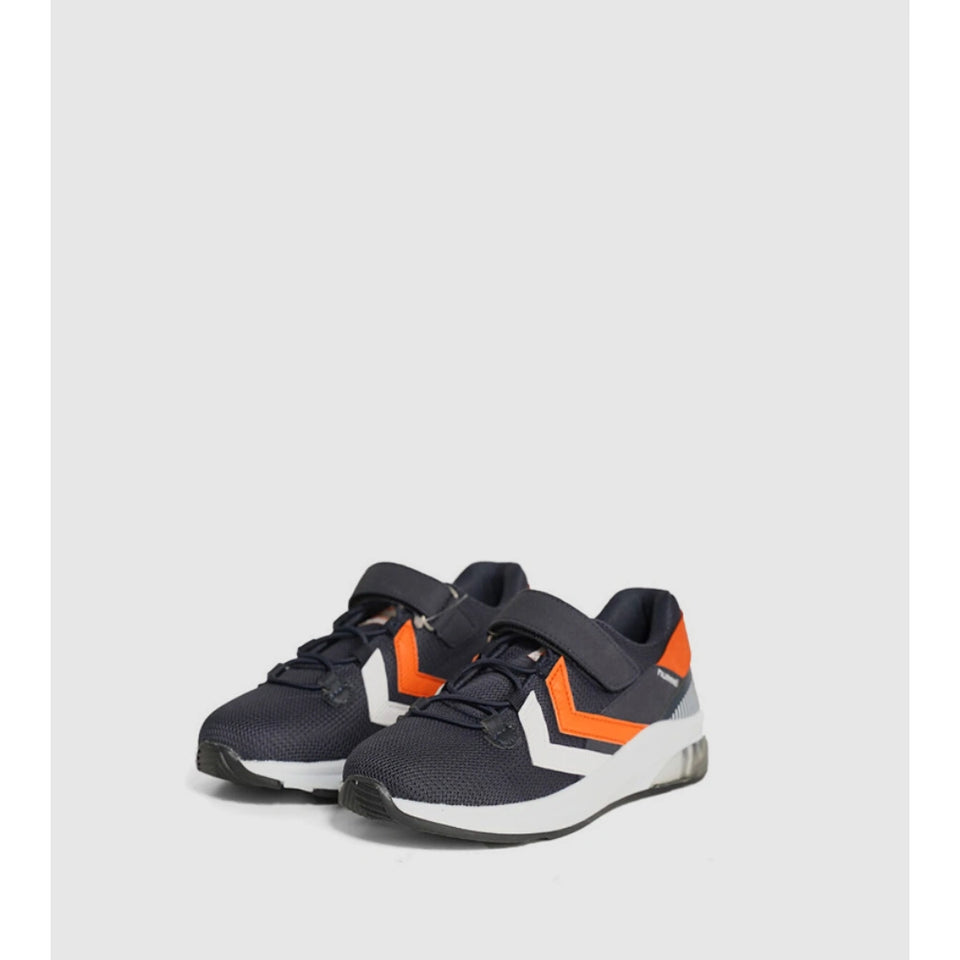 A pair of kids' athletic sneakers in navy blue with bright orange and white chevron accents, featuring hook-and-loop strap closures, shown against a light gray background.