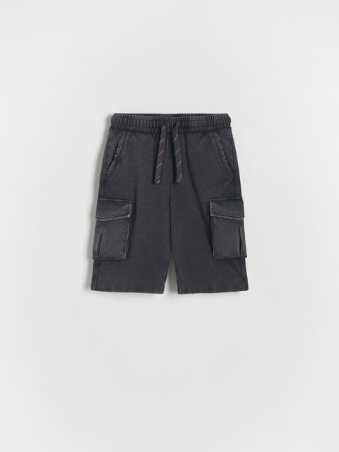 Dark gray cargo shorts with pockets and drawstring on a light gray background