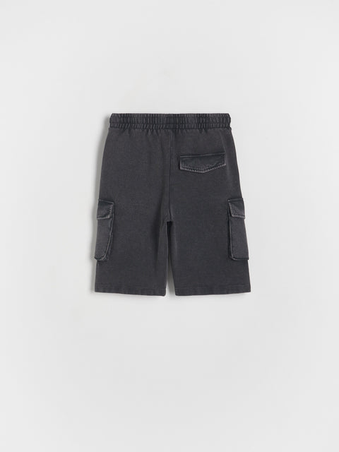 Black cargo shorts on a light gray background