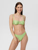 Woman wearing a green checkered bikini against a white background