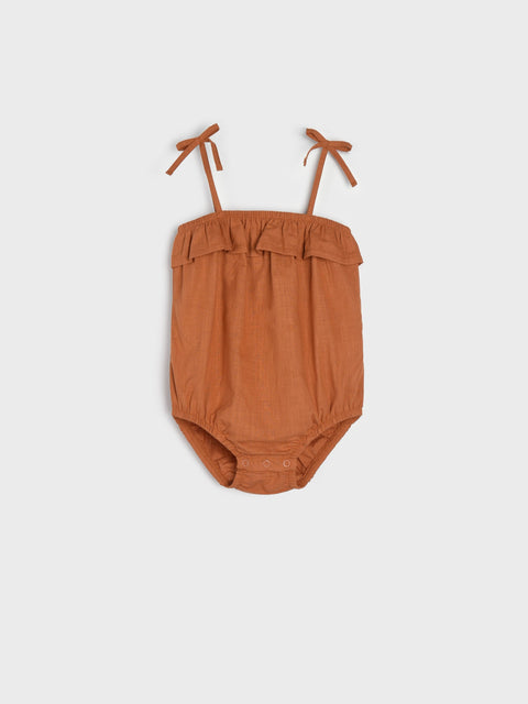 Brown baby romper with thin straps on a white background