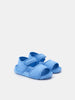 Pair of blue sandals on a light gray background