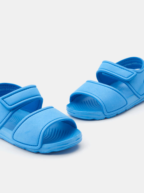 Pair of blue sandals on a light gray background