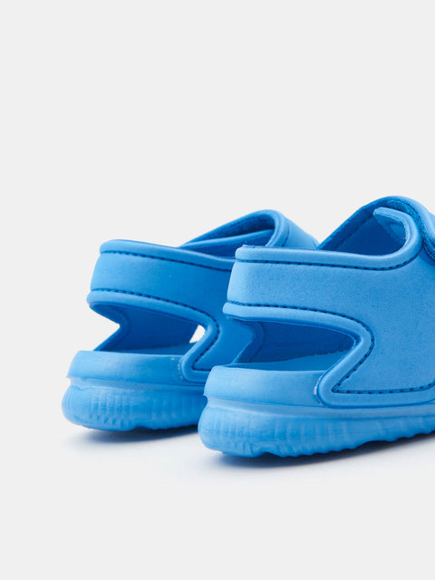 Pair of blue children's sandals on a light gray background
