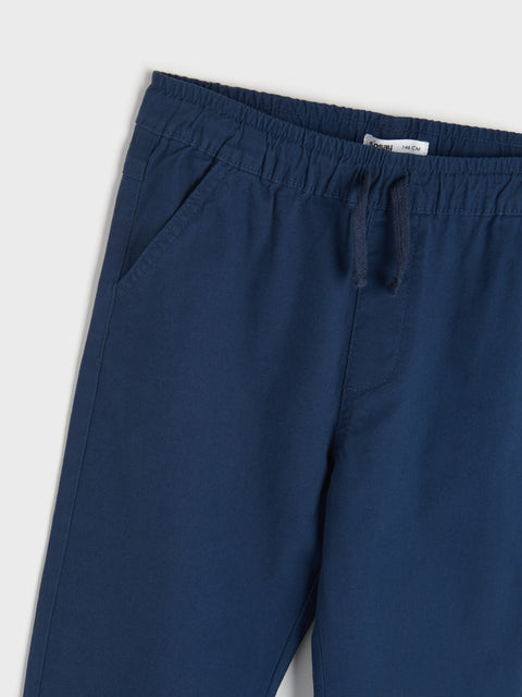 Navy blue pants with a drawstring on a light gray background