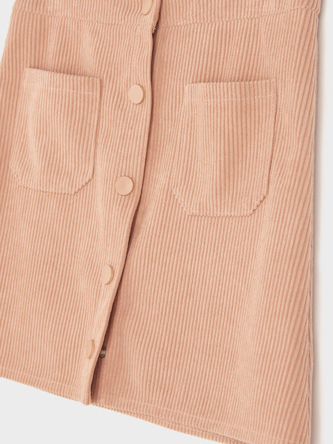 Close-up of a beige corduroy shirt with button details on a white background