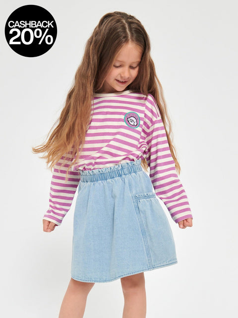 Young girl wearing a striped shirt and denim skirt on a white background with a cashback 20% badge.