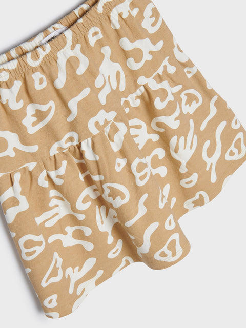 Beige shorts with white abstract patterns on a white background