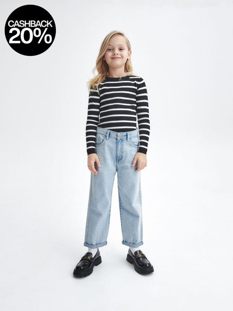 Child wearing a black and white striped shirt and light blue jeans on a white background with a cashback 20% badge.