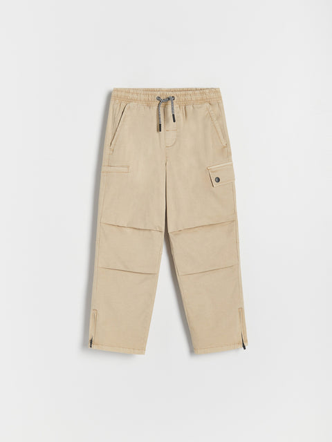 Beige cargo pants on a white background
