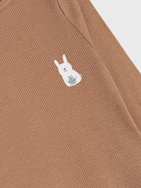 Brown fabric with a white embroidered llama design on a white background