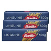 Three packages of Barilla Linguine pasta on a white background