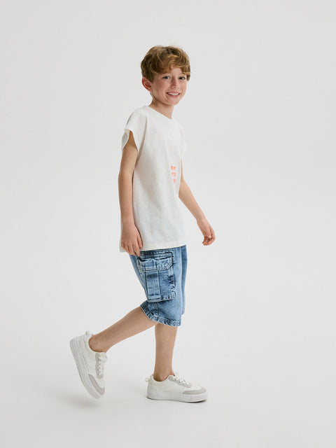 Child wearing a white t-shirt and denim shorts on a white background