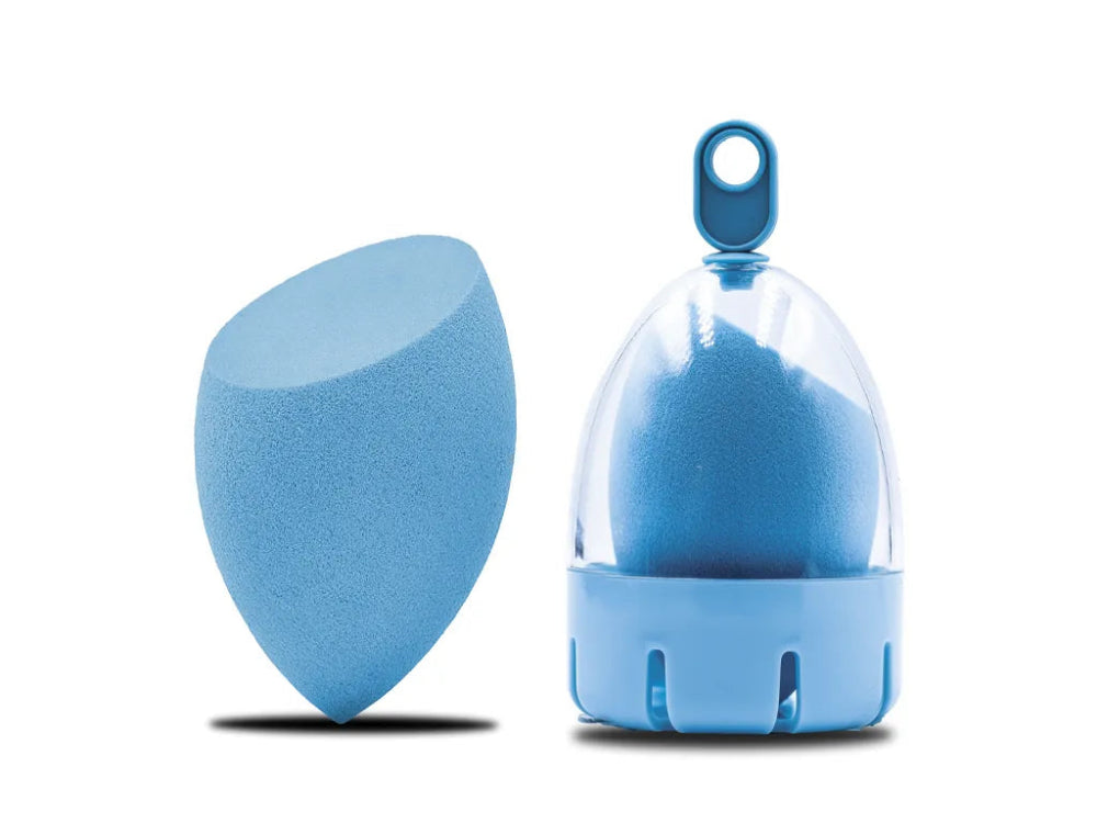 A blue beauty blender sponge with a flat end, displayed alongside its packaging.