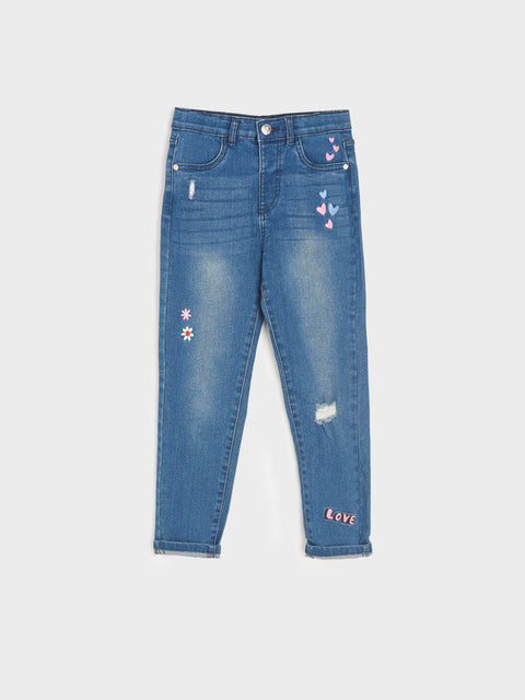 Blue jeans with floral and heart designs on a white background