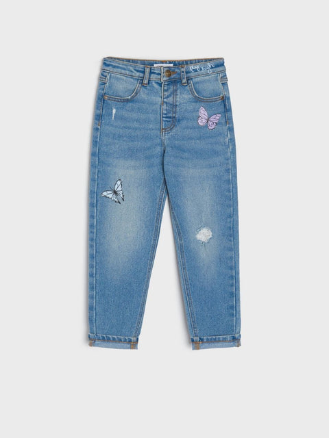 Blue jeans with butterfly patches on a white background