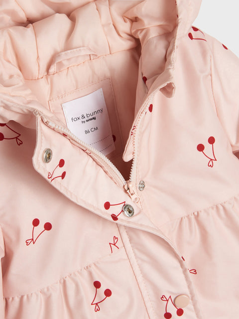 Close-up of a pink jacket with red berry patterns and a 'fox & bunny' label.