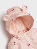 Pink children's raincoat with cherry designs on a light background