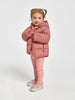 Child wearing a pink puffer outfit on a white background