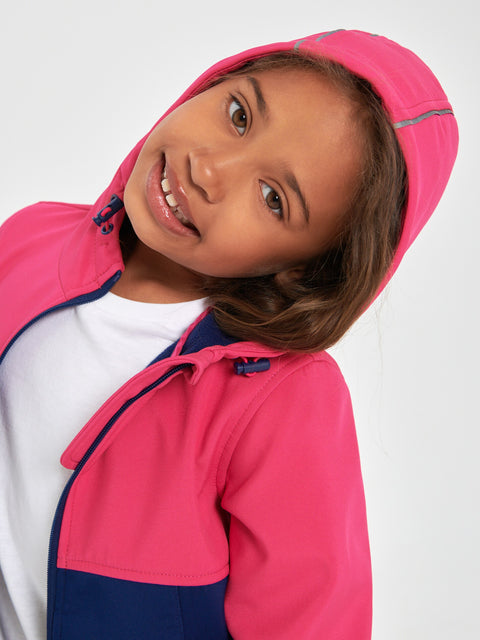 Child wearing a pink and navy raincoat on a white background