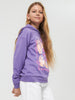 Young girl wearing a purple hoodie with a graphic design on a white background
