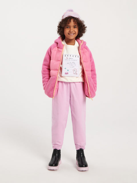 Child wearing a pink puffer jacket and pants on a white background