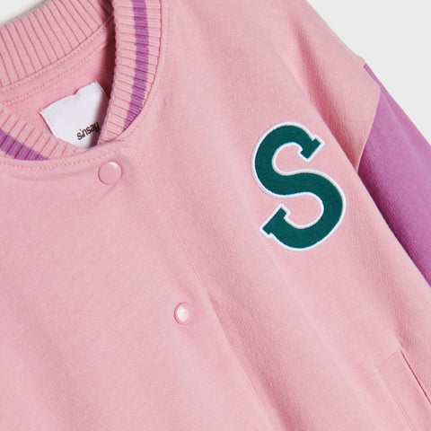 Pink varsity jacket with a green 'S' logo on a white background