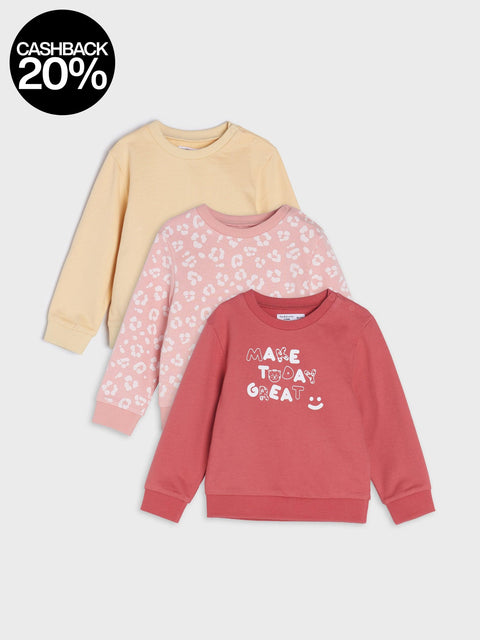 Three children's sweatshirts in different colors on a light gray background