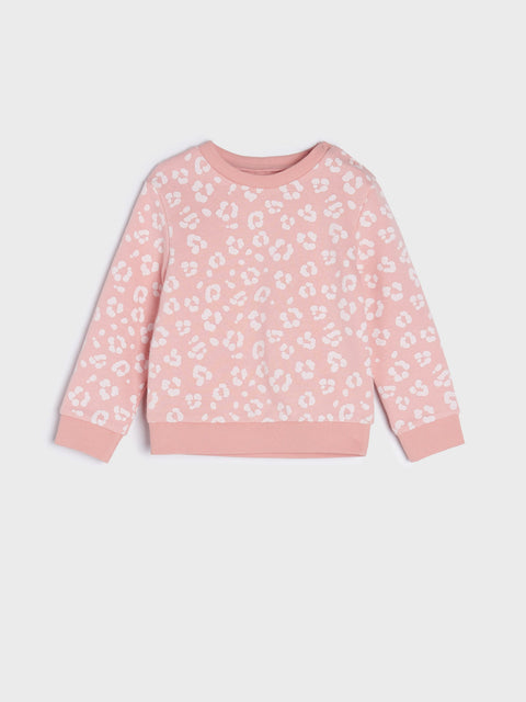 Pink sweatshirt with white floral pattern on a light gray background