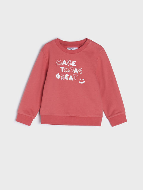 Red children's sweatshirt with text on a light gray background