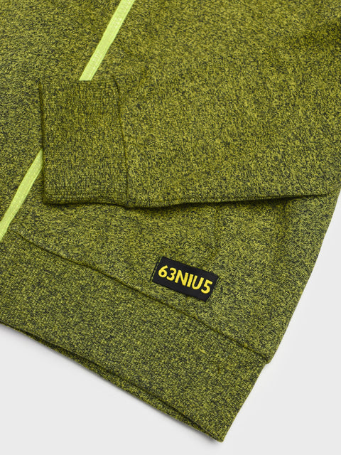 Green textured fabric with a '63NIUS' label on a white background