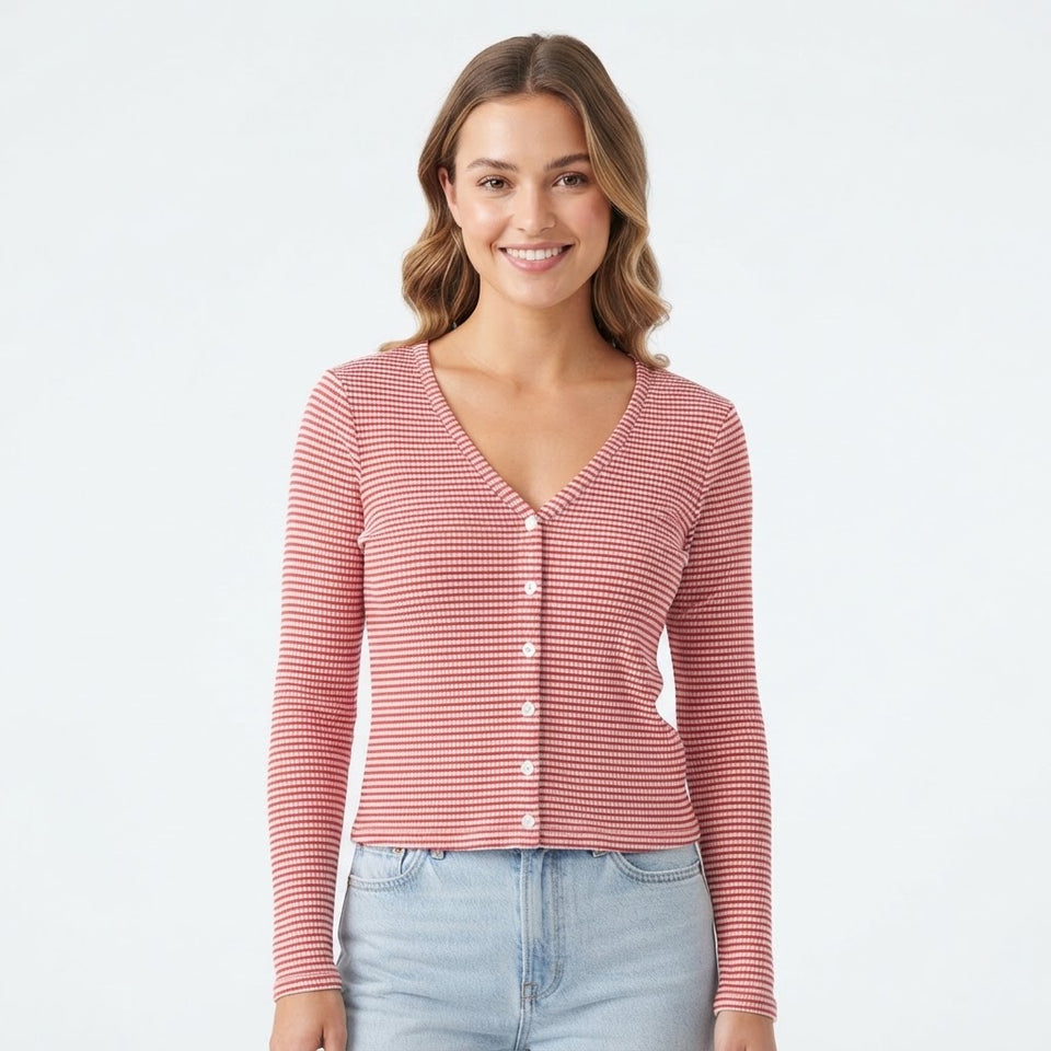 A woman wearing a pink and white horizontally striped long-sleeve button-up cardigan with white buttons, paired with light blue jeans, against a plain white background.