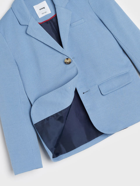 Light blue blazer with a button on a white background