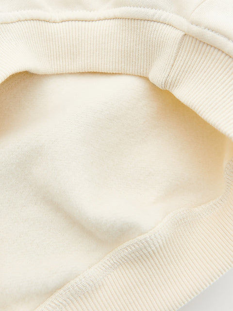 Close-up of a beige sweater with a soft texture