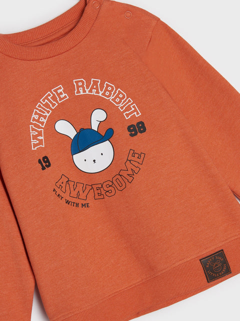 Orange sweatshirt with a cartoon rabbit design on a white background