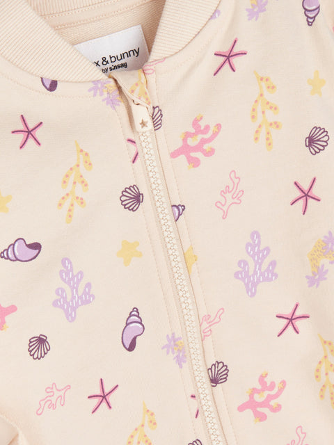Children's jacket with sea-themed pattern and brand label on beige background
