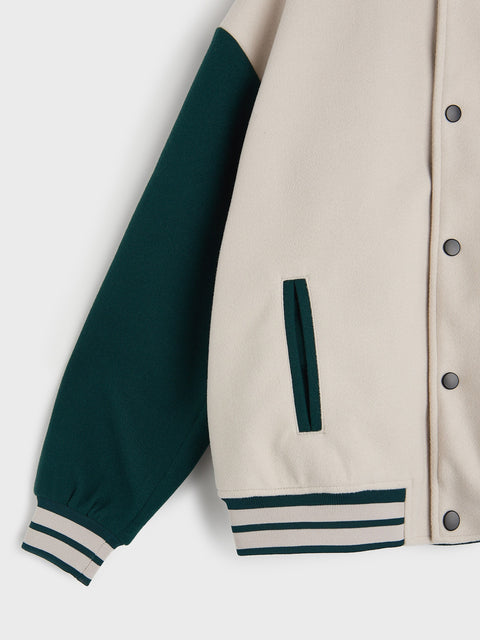 Varsity jacket with green sleeves and beige body on a white background