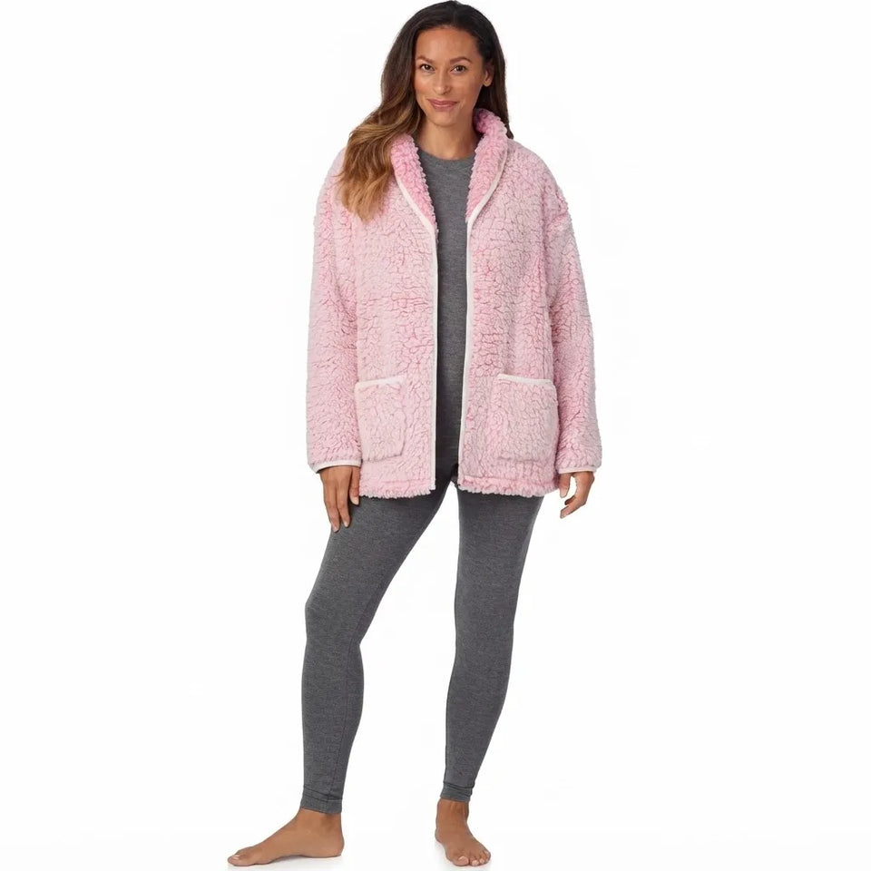 A woman modeling a pink sherpa fleece zip-up hoodie jacket with a hood and front pockets, worn over a gray long-sleeve top and gray leggings, against a plain white background.